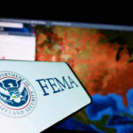 Trump’s FEMA Rewrite Tests States FEMA logo near a US map on screen.