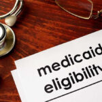 Medicaid Kickbacks, Fake Trips—Taxpayers Fleeced Stethoscope pen document about Medicaid eligibility on table