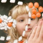 Personhood Push: Trump’s Quiet Power Move A child observing colorful pills floating in the air