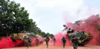 960 Mines, Zero Drivers—What Could Go Wrong? Soldiers running from armored vehicles with red smoke.