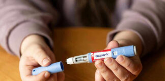Why The VA Fine Print Blocks Ozempic Hands holding an Ozempic injection pen.
