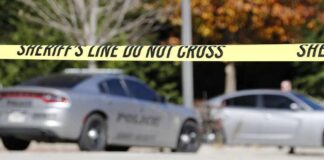 Dental X-Ray Room Horror Exposed Sheriff's line tape blocking a street with police cars behind