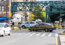Historic Murder Crash, Mystery Deepens Police cars block a city intersection with yellow crime scene tape