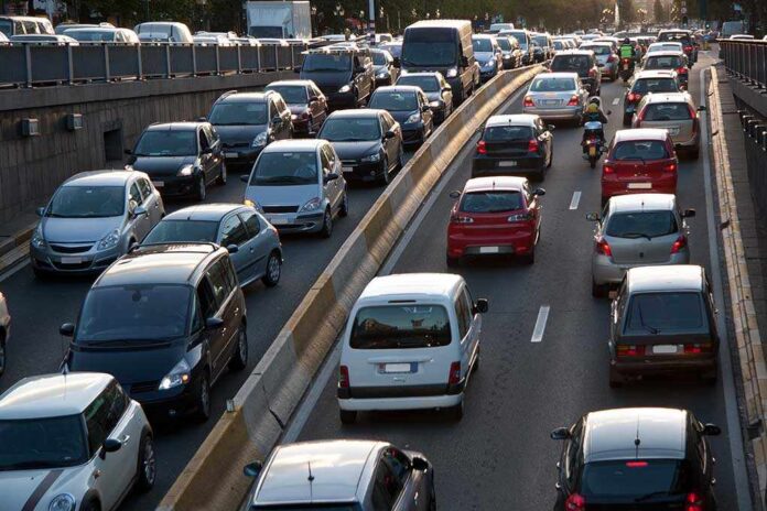 Cars,And,Motorcycles,Going,Along,The,Four,Lane,Highway. Heavy traffic on a city highway during rush hour