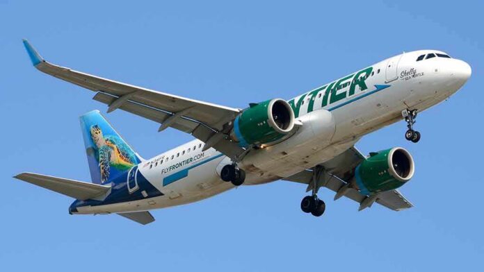 Airliner with green engines flying against a clear blue sky