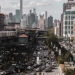 City street with heavy traffic and elevated subway tracks