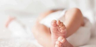 baby feet on a soft white blanket