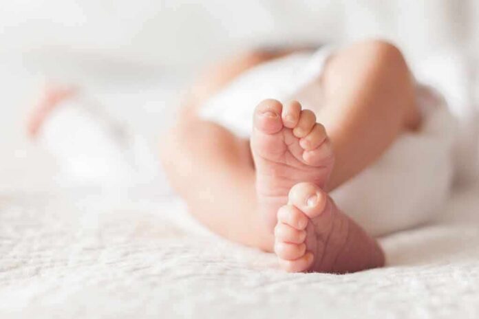 baby feet on a soft white blanket