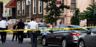 Felony Murder Twist Stunned The Case Police at urban street crime scene with yellow tape around parked cars
