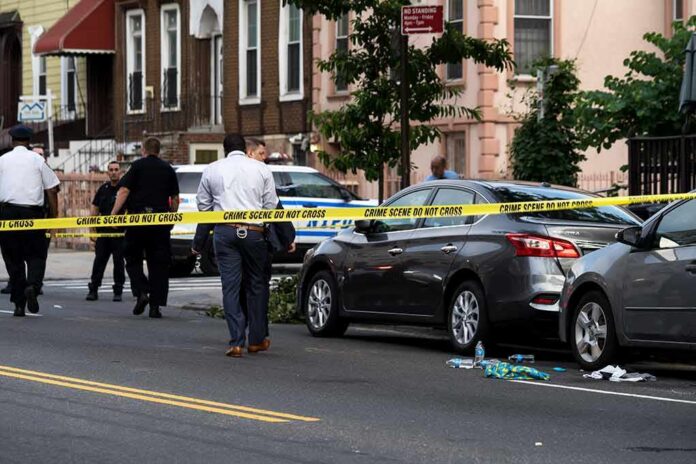 Police at urban street crime scene with yellow tape around parked cars