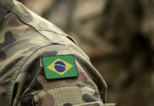 Drought Triggered Deadly Monkey‑Mosquito Chain Brazil flag patch on a camouflage military uniform sleeve