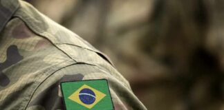 Brazil flag patch on a camouflage military uniform sleeve