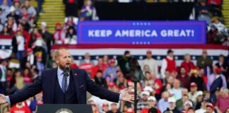GOP Revolt Builds — Miller Wires $1M Speaker at podium addressing large crowd at political rally
