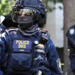 Riot police officer in tactical gear with helmet and visor