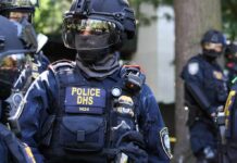 Riot police officer in tactical gear with helmet and visor
