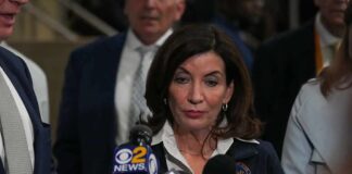 Hijab Uproar Engulfs New York Woman speaking to reporters at a press scrum
