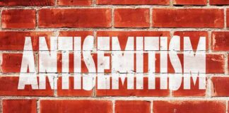 Brick wall with large white stencil text