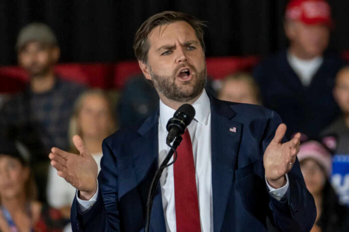 54801cb8-0515-4c34-a2d8-f79705e6683e_shutterstock2542628059jpg Man in suit speaking at a podium