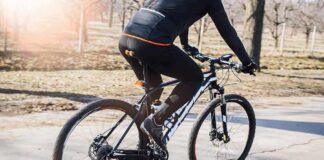 Wealthy Coastal Bike Path Hides Fiery Surprise cyclist riding a mountain bike on a paved path