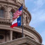 Texas Abortion Ban BLAMED for Woman’s Death Texas and U.S. flags in front of a capitol building dome