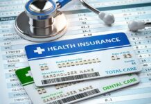 Health insurance cards on medical forms with stethoscope