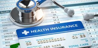 Health insurance cards on medical forms with stethoscope