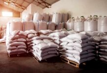 Stacked white sacks on pallets in a warehouse