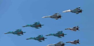 Trump and Vance Downplay Iran A formation of military jet fighters flying in a clear blue sky