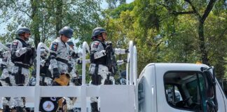 National guard officers standing on a patrol truck