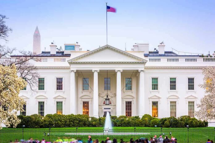 The White House facade with fountain and flag