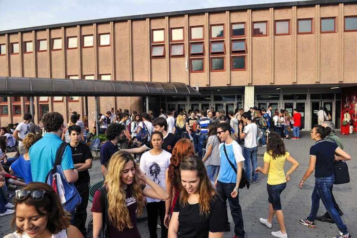 shutterstock_181110272-2 Students gathered outside a school building entrance