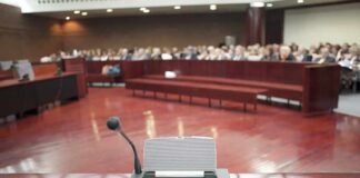 Mayor’s ‘Teen Groping’ Claim Sparks Late-Night Visit Conference microphone on a podium in a courtroom