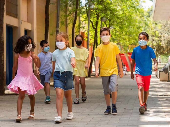 Group of children wearing face masks walking outdoors
