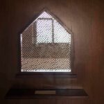 Confessional booth window with lattice screen