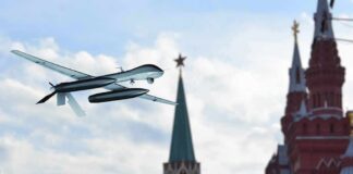 military drone flying near ornate red-brick towers