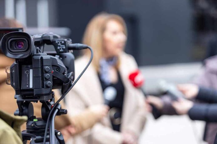 Video camera filming an outdoor media interview