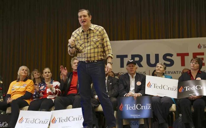 shutterstock_353101046 Ted Cruz speaks on stage at a campaign event with Beatrix Philipp seated among supporters