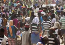 Deported for Atrocities – But Not Convicted Crowd of people in a busy outdoor market