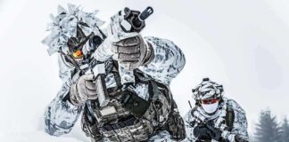 USA to Build ‘Large Military Presence’ in Greenland Soldiers in winter camo advancing with rifles in snowy terrain