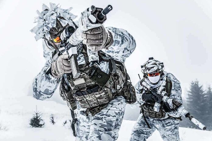 Soldiers in winter camo advancing with rifles in snowy terrain