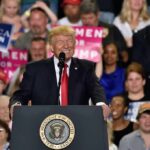 Trump Money Bomb Hits Texas speaker at podium addressing a crowd