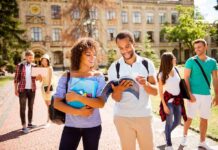 College students walking on campus with books and backpacks