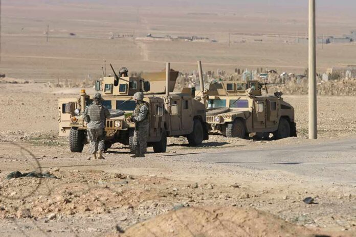 Soldiers near armored vehicles in a desert