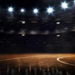 Basketball court under bright arena lights