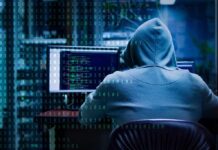What Trump Wants Done to Military LEAKERS Person in hoodie working at computer with code on screens