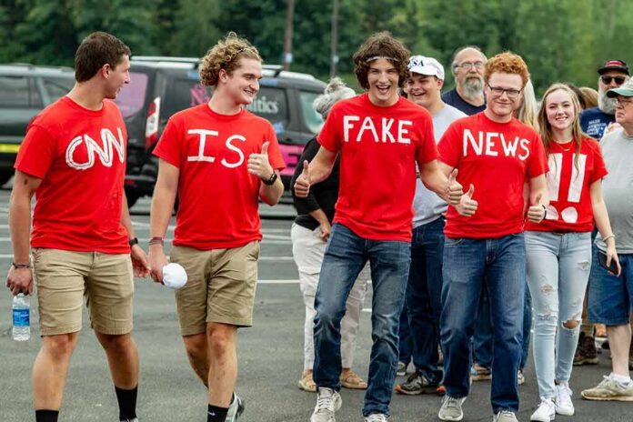 Group of young people in red shirts walking and giving thumbs up