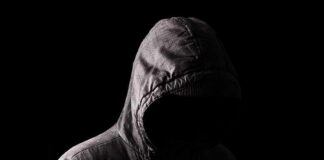 Stalker Must Warn Every Future DATE Hooded figure in shadow on black background