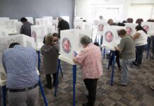 California Election Officials SUBPOENAED Voters fill out ballots at polling booths in a busy voting room