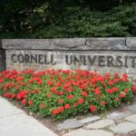 Cornell Students DEMAND Answers Over Assault Claims Cornell University stone sign with red flowers