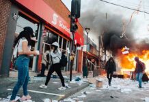 Masked Rioter Gets Instant KARMA Street protest with fire and smoke outside a bank